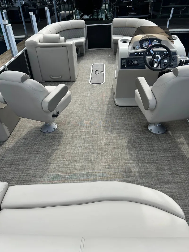 Slide: The Image of Interior of a 2020 Harris Sunliner 250 pontoon boat with beige seating. - 13