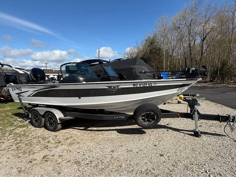 Slide: The Image of 2020 Lund 2175PROV boat parked on trailer outdoors. - 2