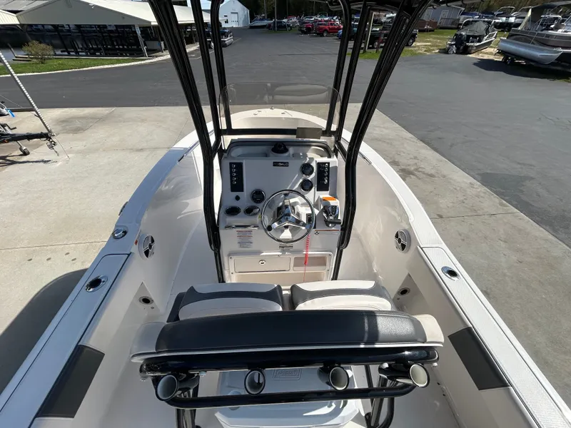 Slide: The Image of Interior view of a 2018 Robalo R180CC boat, showing console and seating. - 10