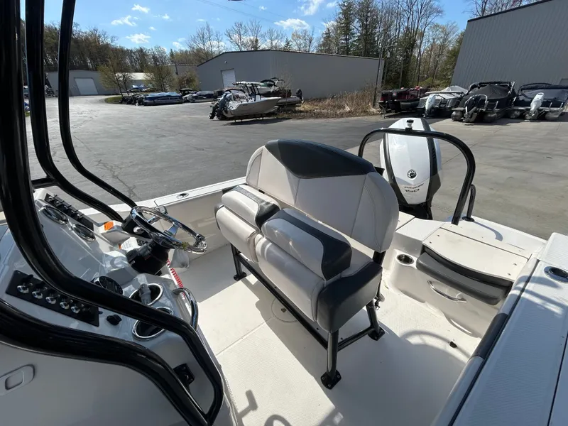 Slide: The Image of Interior view of a 2018 Robalo R180CC boat with steering console. - 11