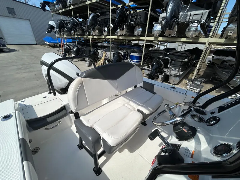 Slide: The Image of Interior view of a 2018 Robalo R180CC boat with steering console. - 12