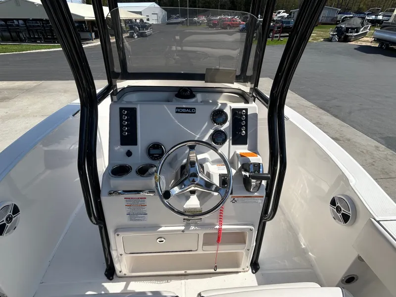 Slide: The Image of Steering console of a 2018 Robalo R180CC boat. - 13