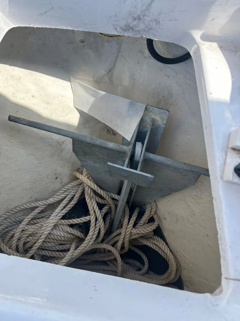 Slide: The Image of Anchor and rope in storage compartment of a 2018 Robalo R180CC boat. - 18