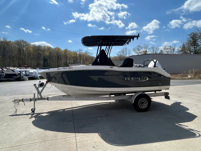 Slide: The Image of 2018 Robalo R180CC boat on trailer under sunny skies. - 3