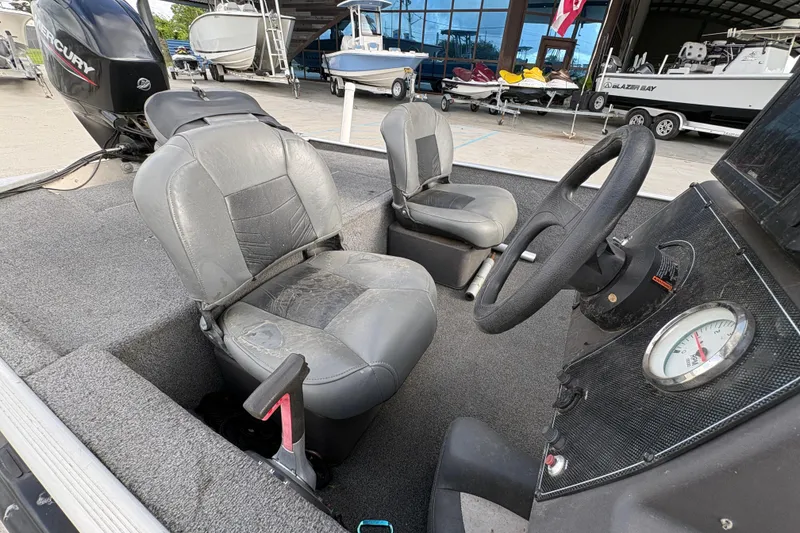 Slide: The Image of 2020 Tracker Bass Tracker Classic XL boat interior with steering wheel and seats. - 17