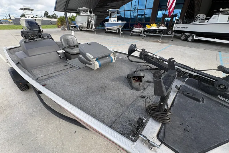 Slide: The Image of 2020 Tracker Bass Tracker Classic XL boat with fishing deck and motor, parked outdoors. - 20