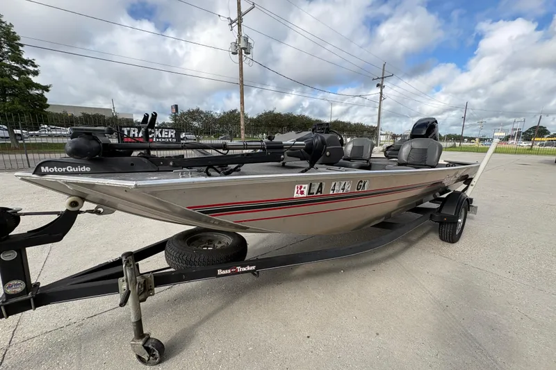 Slide: The Image of 2020 Tracker Bass Tracker Classic XL boat on trailer, parked outdoors under cloudy sky. - 7
