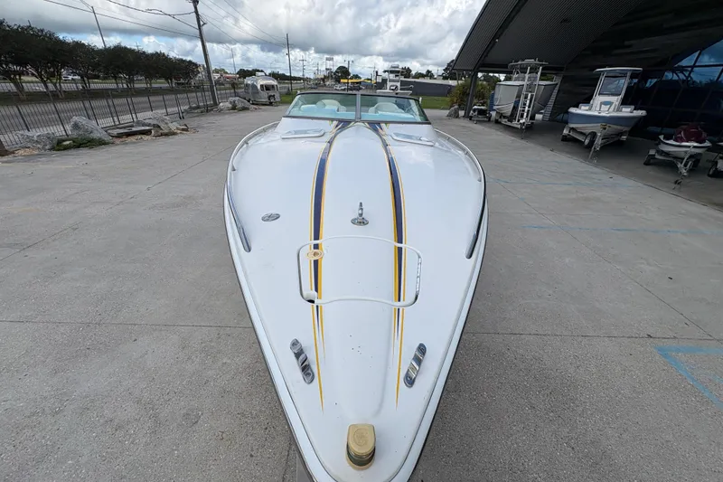 Slide: The Image of 2002 Formula 292 FASTech boat with sleek design, parked outdoors on concrete surface. - 11