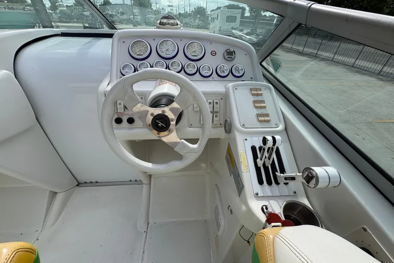 Slide: The Image of 2002 Formula 292 FASTech boat cockpit with steering wheel and control panel. - 19