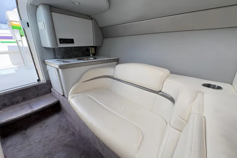 Slide: The Image of Interior of 2002 Formula 292 FASTech boat with white seating and compact kitchenette. - 24