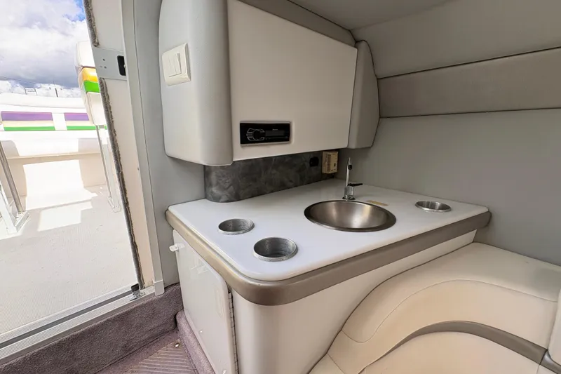 Slide: The Image of Interior of a 2002 Formula 292 FASTech boat featuring a compact sink and seating area. - 26