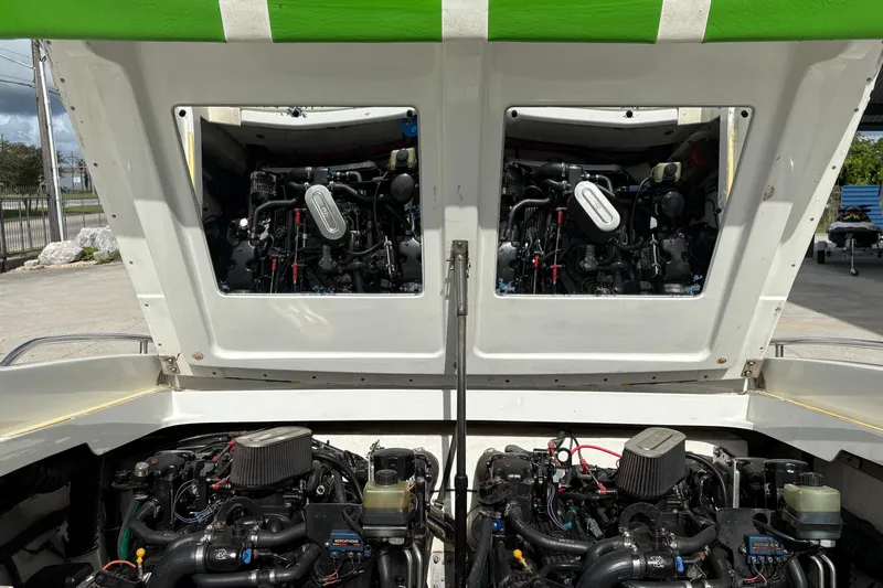 Slide: The Image of 2002 Formula 292 FASTech boat engines exposed under open hatch, showcasing dual power systems. - 27