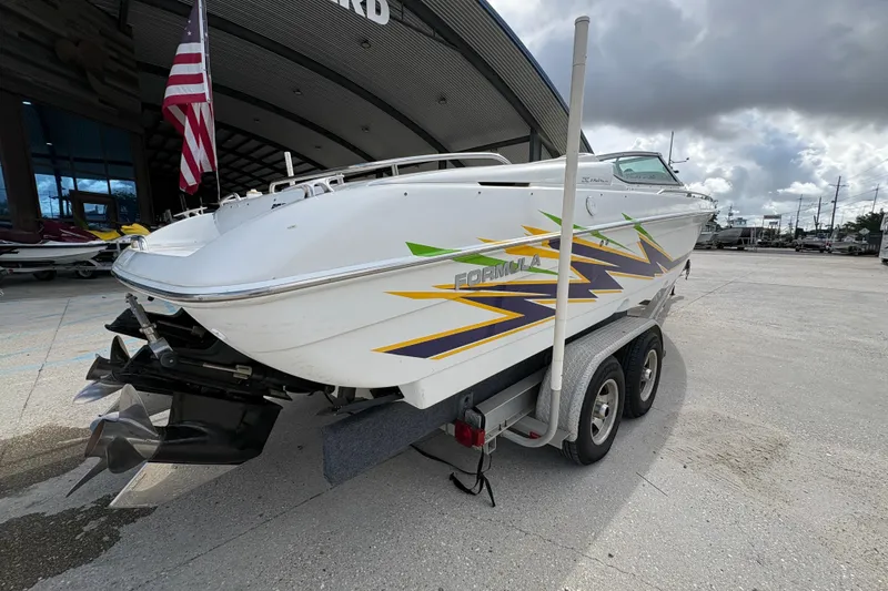 Slide: The Image of 2002 Formula 292 FASTech boat on trailer, featuring vibrant graphics and dual propellers. - 4