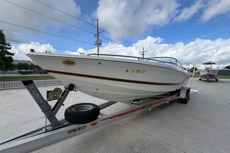 Slide: The Image of 2002 Formula 292 FASTech boat on trailer under cloudy sky. - 8