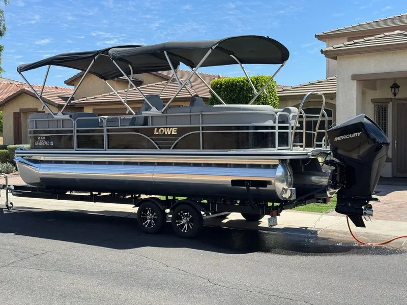 The Image of Lowe SS 2021 pontoon boat with Mercury engine on trailer. - 0