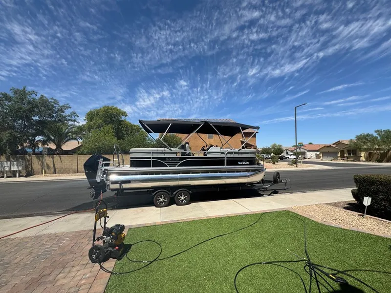 Slide: The Image of 2021 Lowe SS pontoon boat on trailer in residential area. - 9