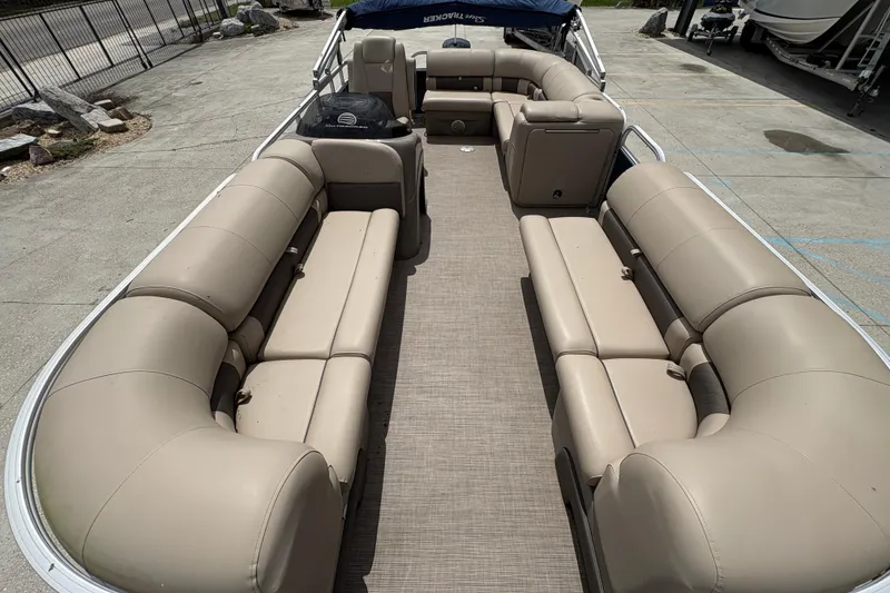 Slide: The Image of 2021 Sun Tracker Party Barge 20 DLX with spacious beige seating and open deck layout. - 11
