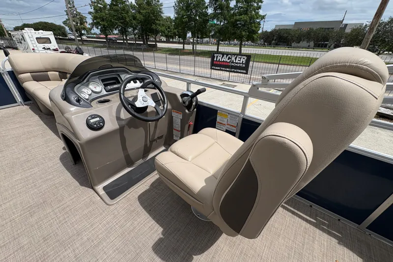 Slide: The Image of 2021 Sun Tracker Party Barge 20 DLX interior with steering console and seating. - 16