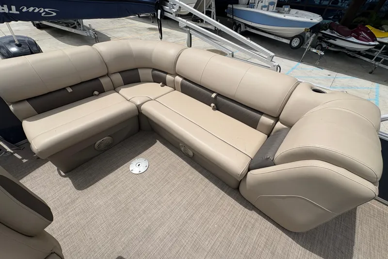 Slide: The Image of 2021 Sun Tracker Party Barge 20 DLX with beige seating and spacious deck layout. - 18