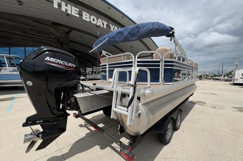 Slide: The Image of 2021 Sun Tracker Party Barge 20 DLX pontoon boat with Mercury engine at a boat dealership. - 4