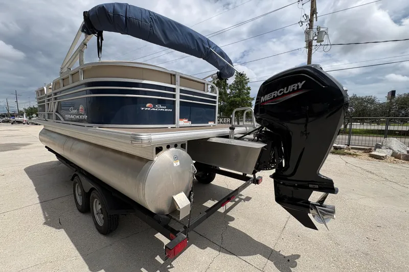 Slide: The Image of 2021 Sun Tracker Party Barge 20 DLX with Mercury outboard motor on trailer. - 6