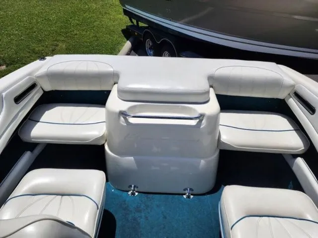Slide: The Image of The image shows the cockpit of a 1998 Sea Ray 190 boat with white leather seats. - 16