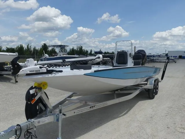 The Image of 2026 Xpress Hyper-Lift H24B boat on trailer under blue sky. - 1