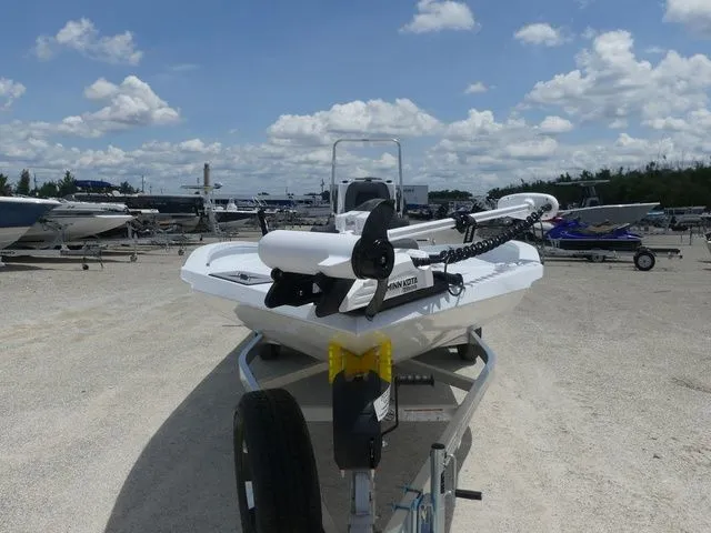 Slide: The Image of 2026 Xpress Hyper-Lift H24B boat on trailer under blue sky. - 2