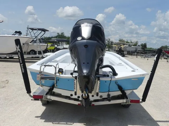 Slide: The Image of Xpress Hyper-Lift H24B 2026 boat with outboard motor on trailer. - 5
