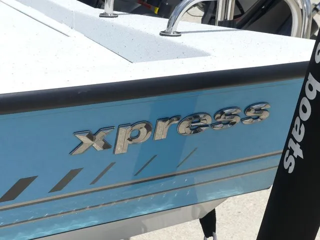 Slide: The Image of 2026 Xpress Hyper-Lift H24B boat with blue hull. - 7