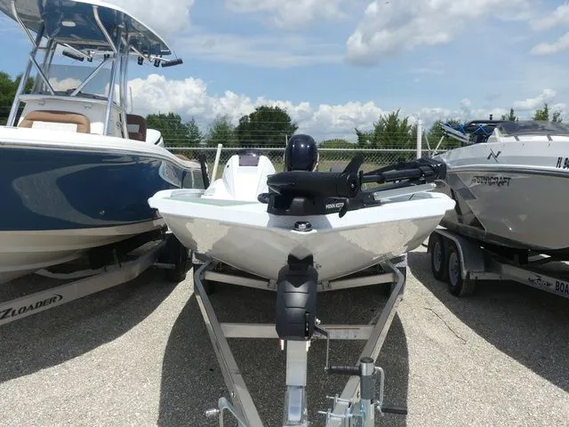 Slide: The Image of 2026 Xpress Hyper Lift H20B boat on trailer, between other boats. - 2