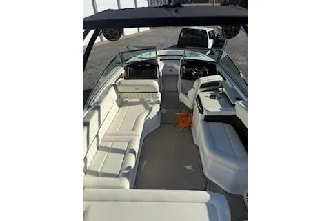 Slide: The Image of 2018 Cobalt A28 boat interior with white seating and modern dashboard. - 10