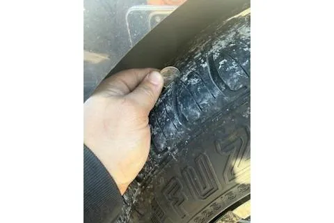 Slide: The Image of Hand checking tire tread depth with a coin on a Cobalt A28, 2018 model. - 12