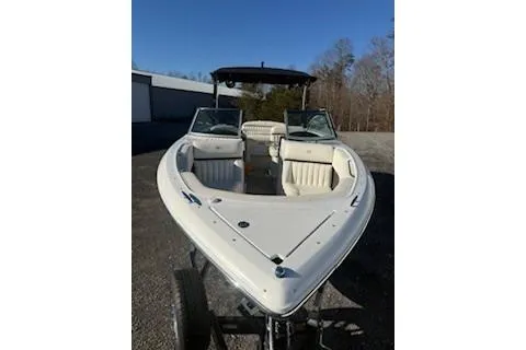 Slide: The Image of 2018 Cobalt A28 boat with open bow, parked outdoors under clear sky. - 13