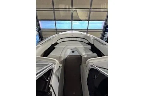 Slide: The Image of 2018 Cobalt A28 boat interior with white seating in a garage setting. - 14