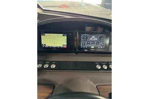 Slide: The Image of Dashboard of a 2018 Cobalt A28 boat with navigation and control screens. - 18