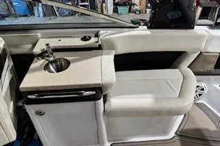Slide: The Image of 2018 Cobalt A28 boat interior with sink and seating area. - 19