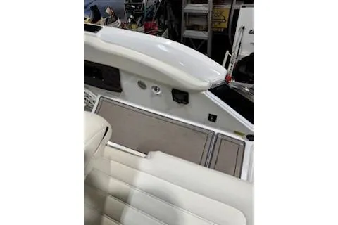 Slide: The Image of Interior view of a 2018 Cobalt A28 boat with white seating and control panel. - 21