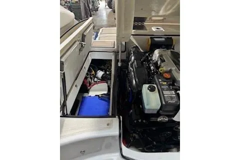 Slide: The Image of 2018 Cobalt A28 boat engine compartment with storage and mechanical components visible. - 24