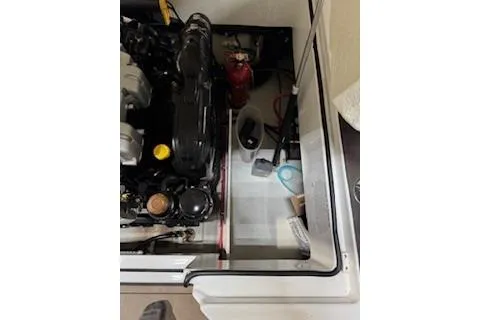 Slide: The Image of Engine compartment of a 2018 Cobalt A28 boat with visible components and tools. - 27