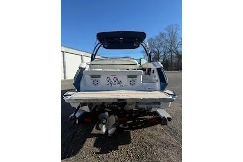 Slide: The Image of 2018 Cobalt A28 boat rear view with "Big Blue" text, parked outdoors. - 3