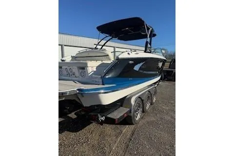 Slide: The Image of 2018 Cobalt A28 boat on trailer, parked outdoors under clear blue sky. - 4