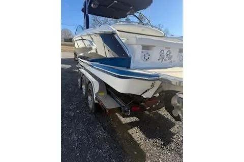 Slide: The Image of 2018 Cobalt A28 boat on trailer, rear view, parked outdoors. - 7