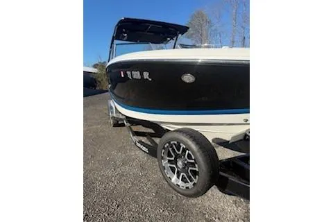 Slide: The Image of 2018 Cobalt A28 boat on trailer, black and white design, parked outdoors. - 8