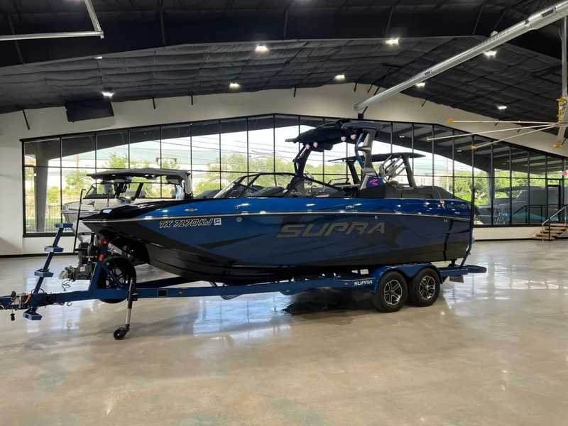 The Image of 2021 Supra SL 400 boat in a modern showroom. - 1