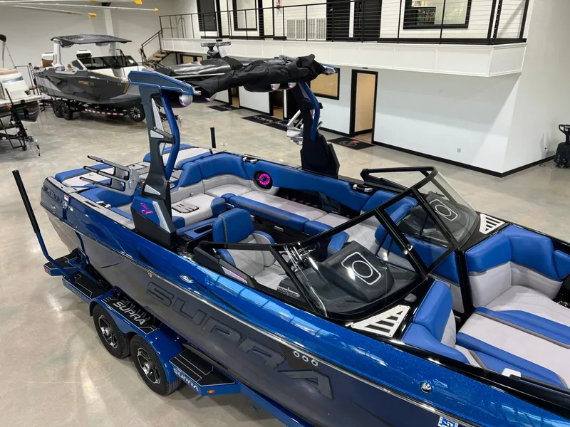 Slide: The Image of 2021 Supra SL 400 boat in a showroom. - 10