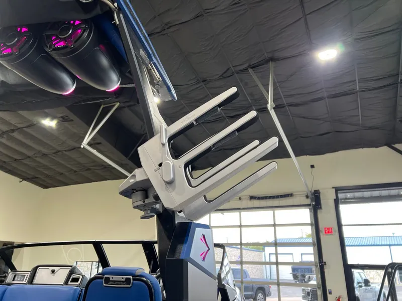 Slide: The Image of 2021 Supra SL 400 boat with modern tower design in a showroom. - 12