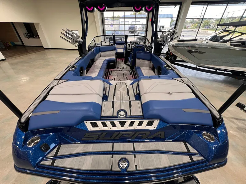 Slide: The Image of Interior view of a 2021 Supra SL 400 boat with blue and gray seating. - 15