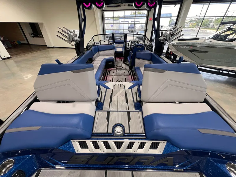 Slide: The Image of Interior of a 2021 Supra SL 400 boat with blue and gray seating. - 16
