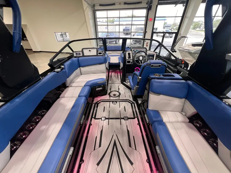 Slide: The Image of Interior of a 2021 Supra SL 400 boat with blue and white seating. - 18